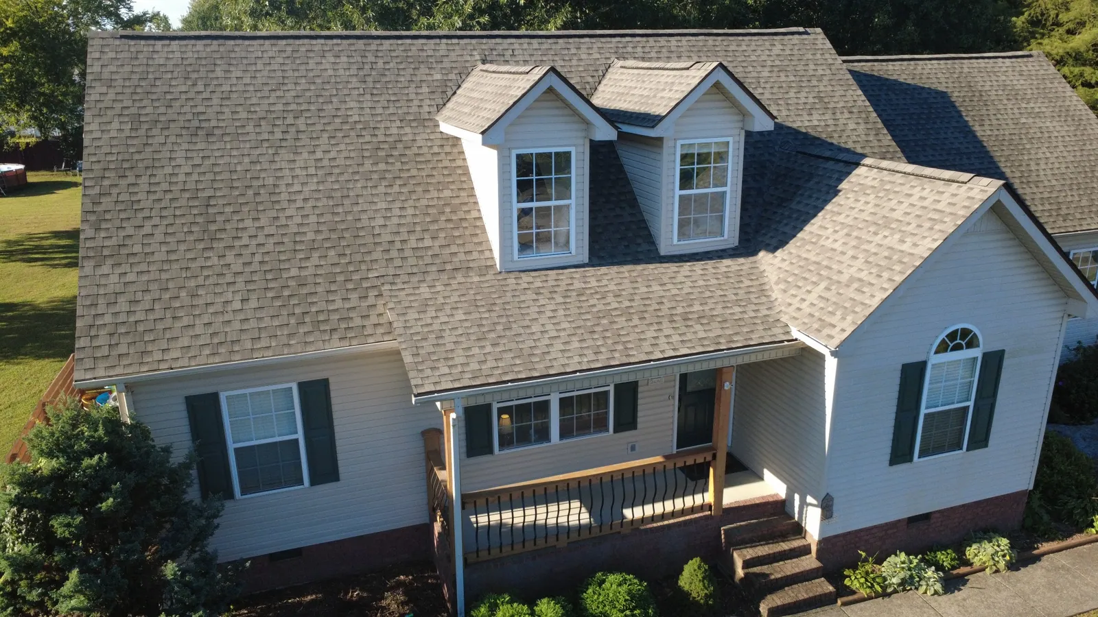 Completed gray architectural shingle roof from an elevated angle